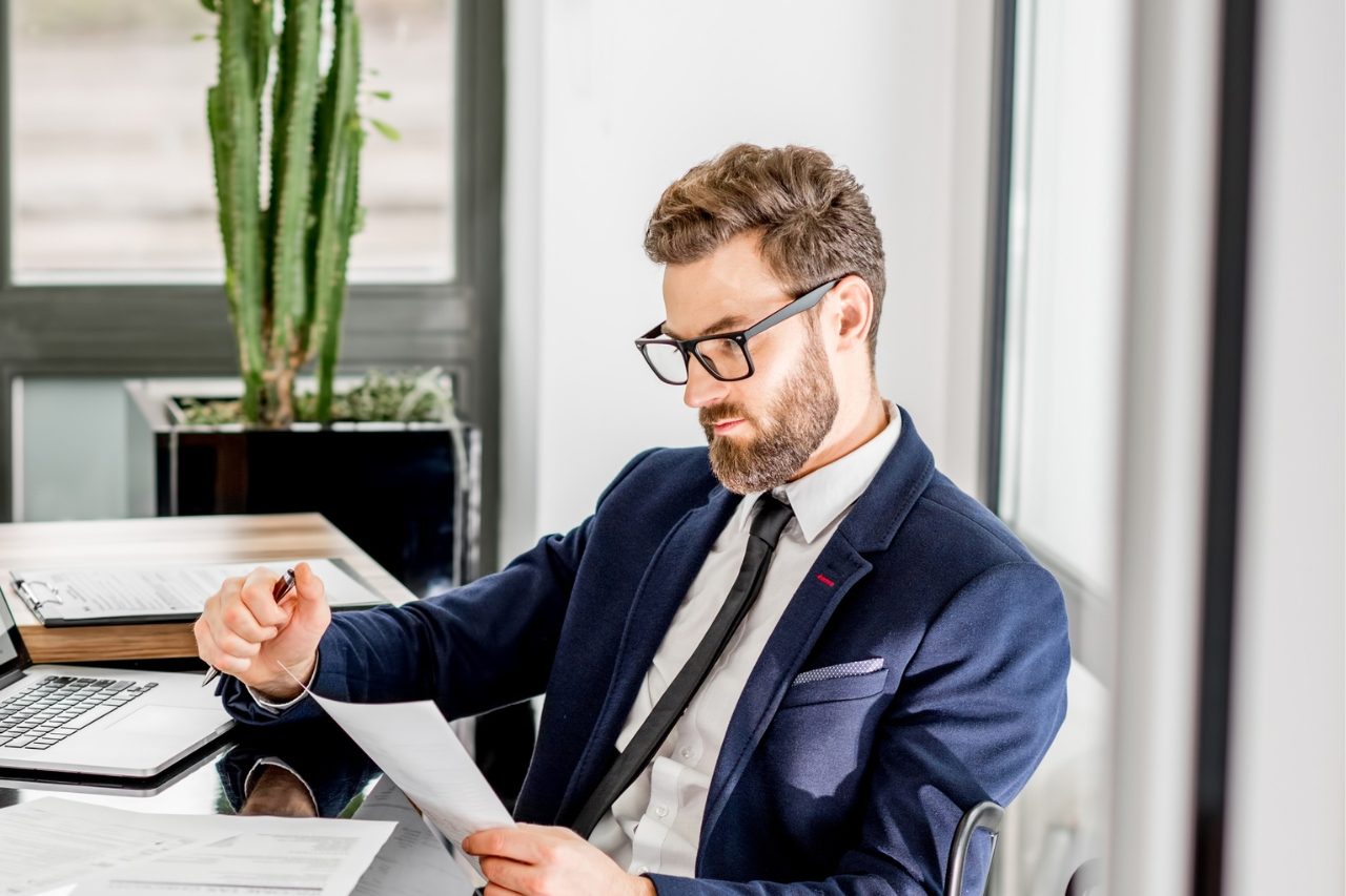 A mortgage professional reviewing a client’s documents at his desk